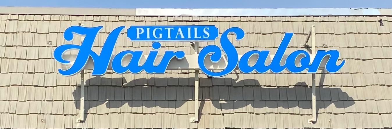 Sign at 1830, listing building A's businesses: Invictus, Laboratory Supply Dist., Custom Cable, and Mek Companies.