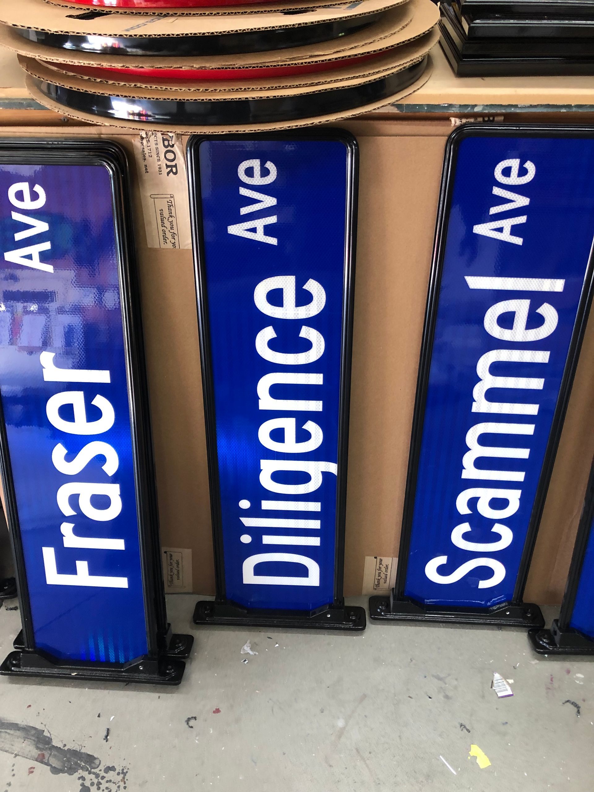 Blue street signs with white text: 