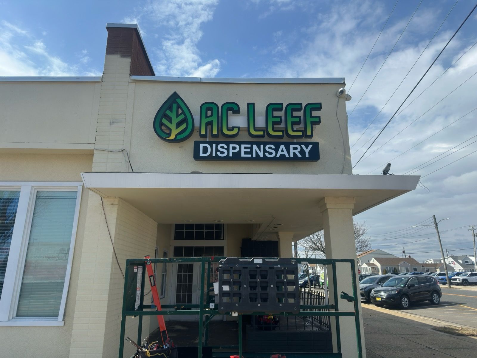 Sign for Katz JCC with green and white elements, and logos for 