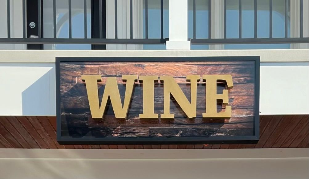 Sign for Virtua Health at Cornerstone, brown and beige with logo, near building and cars.