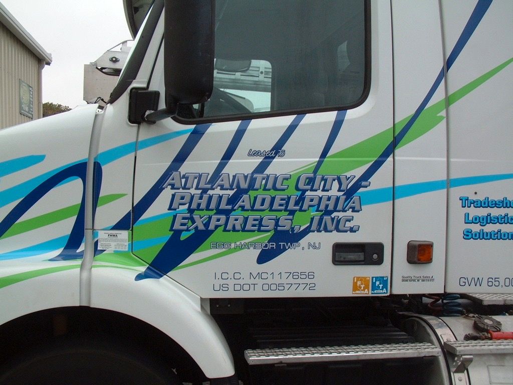 Blue and silver Bacharach Institute for Rehabilitation sign with directional arrows.