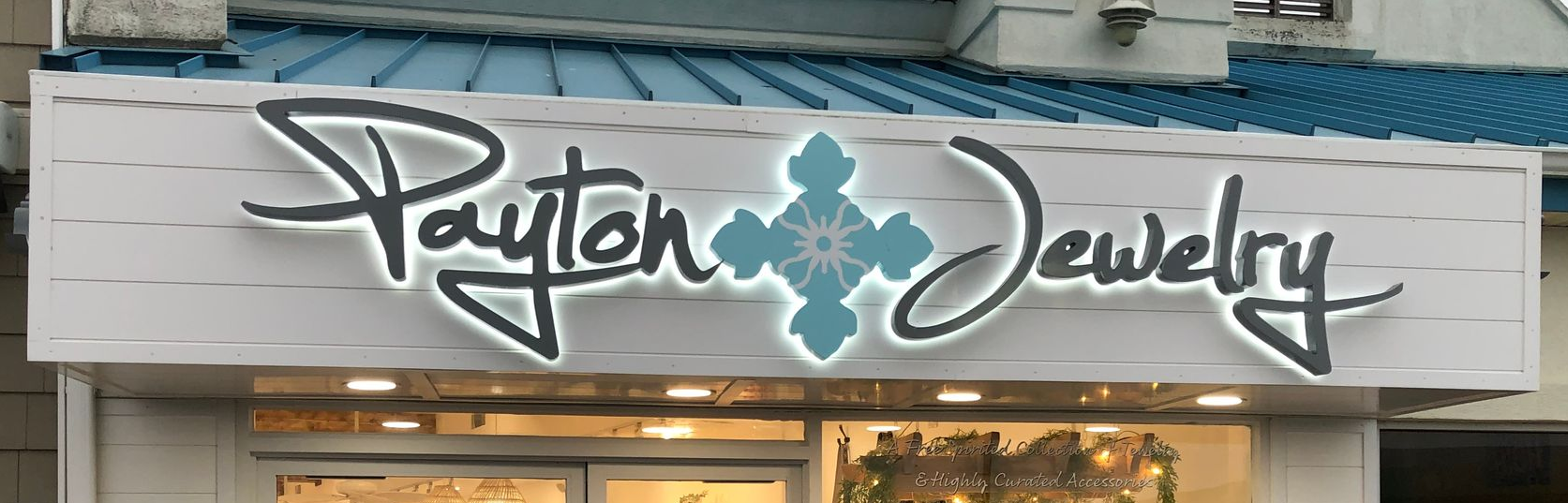 Sign for Payton Jewelry store with blue and white accents.
