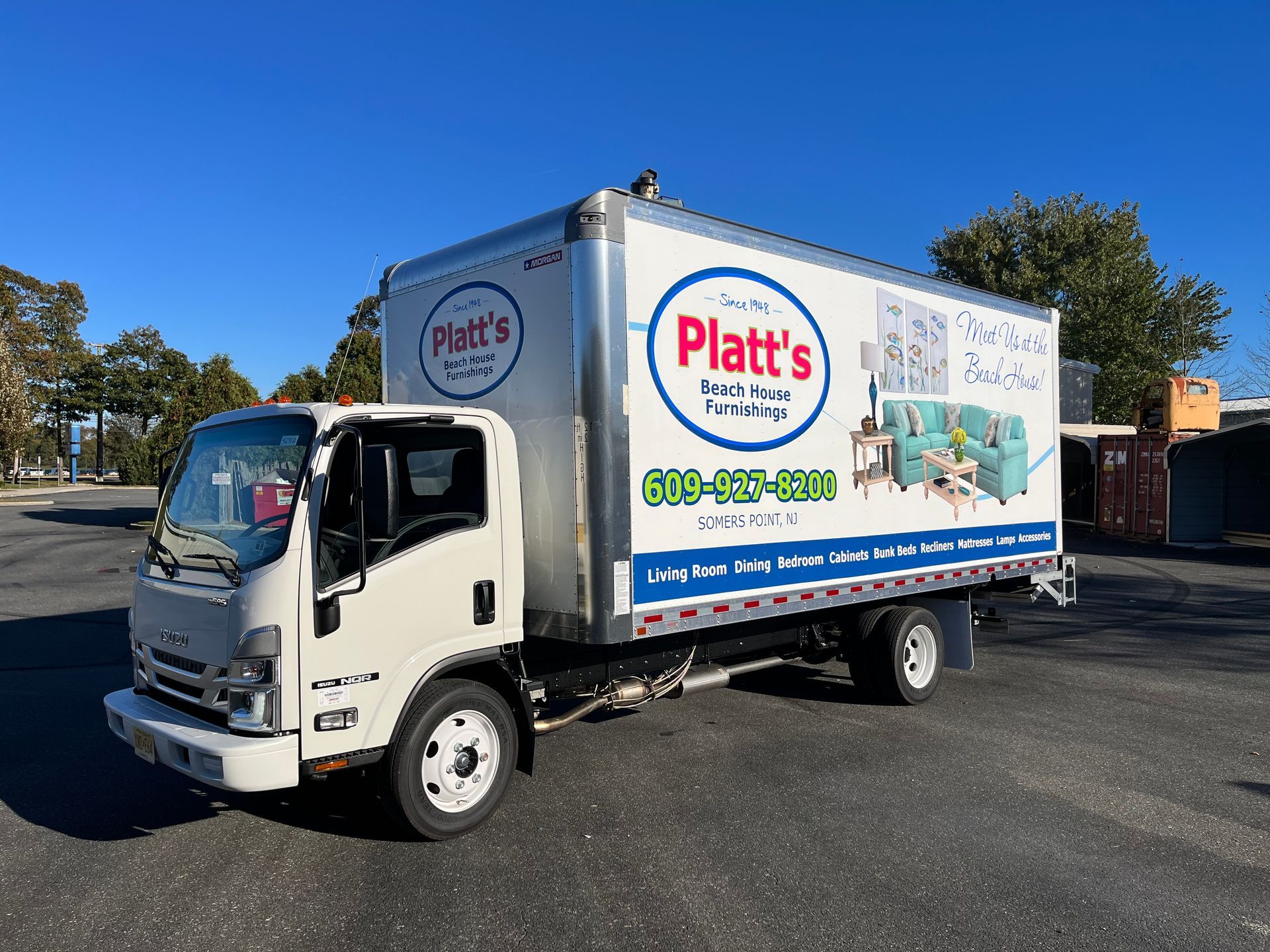 White box truck with Platt's logo on the side, parked outdoors on a sunny day.