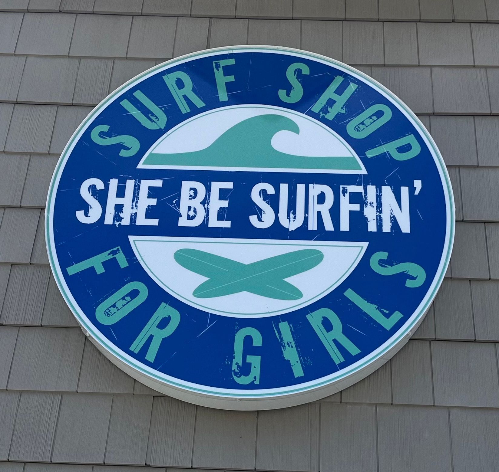 Blue and silver Bacharach Institute for Rehabilitation sign with directional arrows.