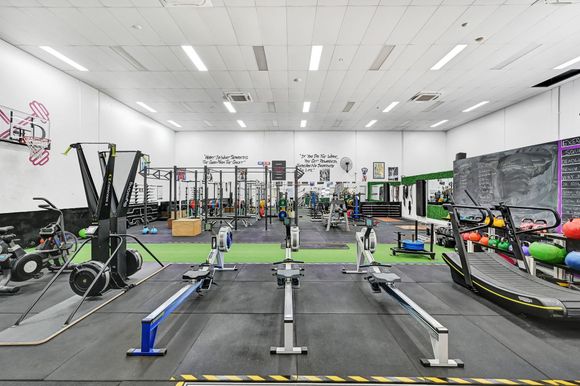 Lifting a barbell — Gym in Townsville