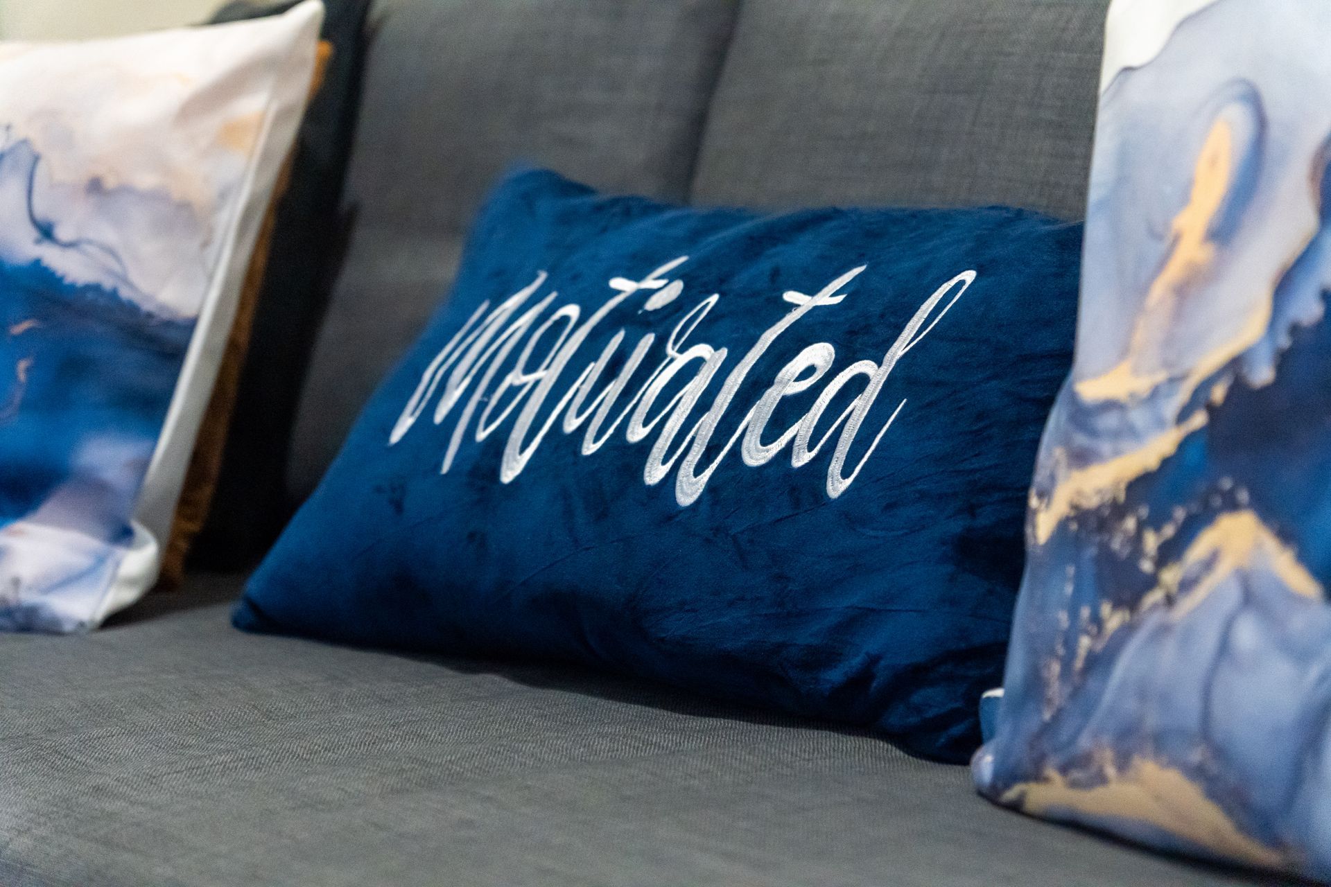 Blue pillow with Motivated on a sofa. Captains Quarters at Bayshore Luxe by Prime, Manila