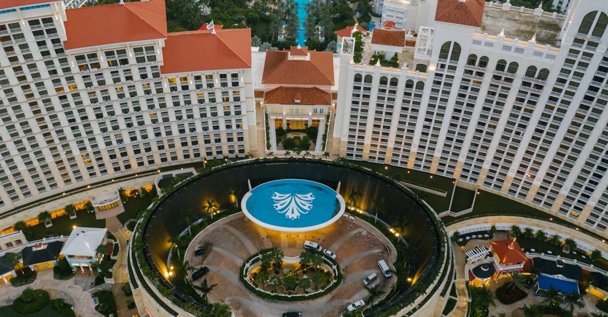 An aerial view of a large building with a pool in the middle of it.