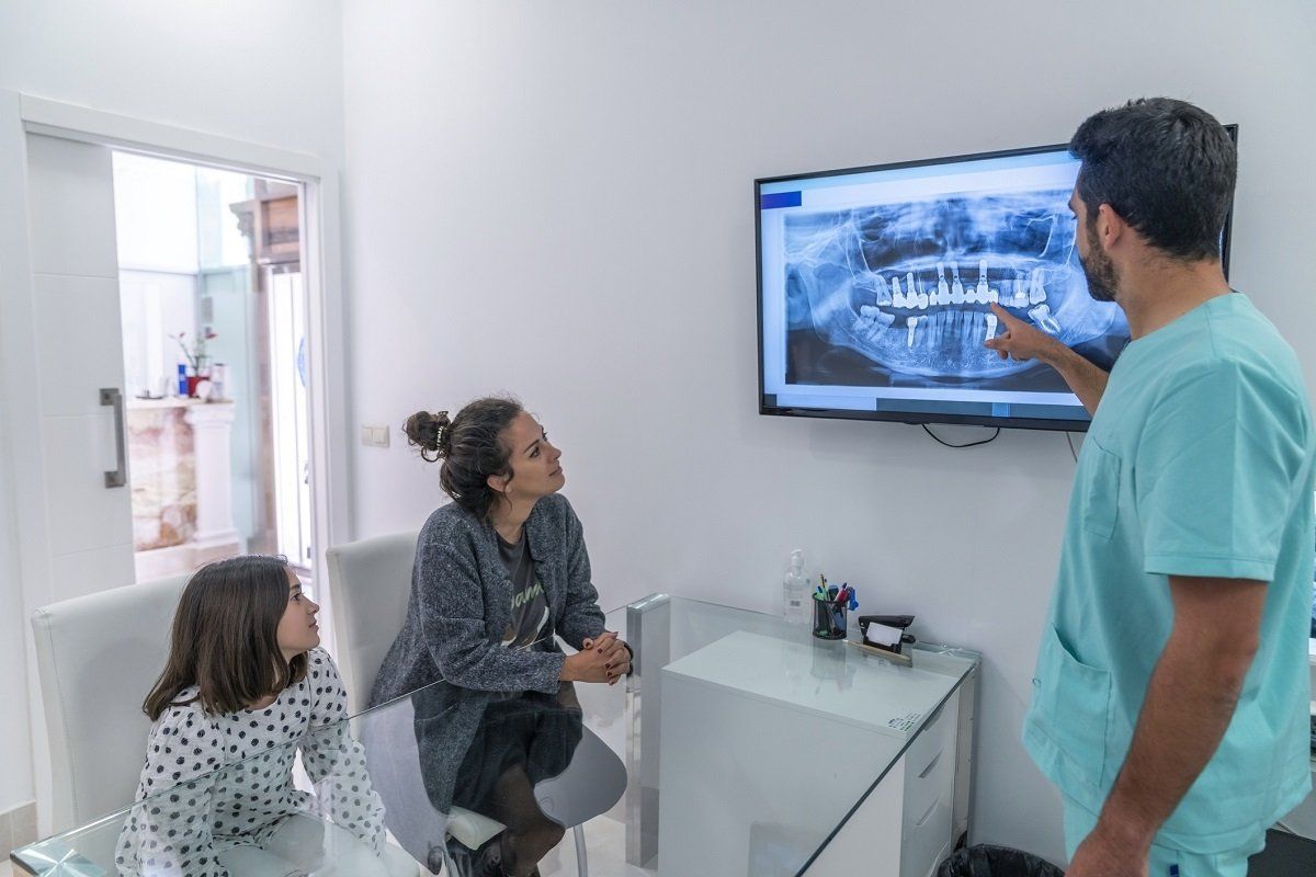 Dentist with patients | Lisbon, OH | Domenic A. DiNello DMD