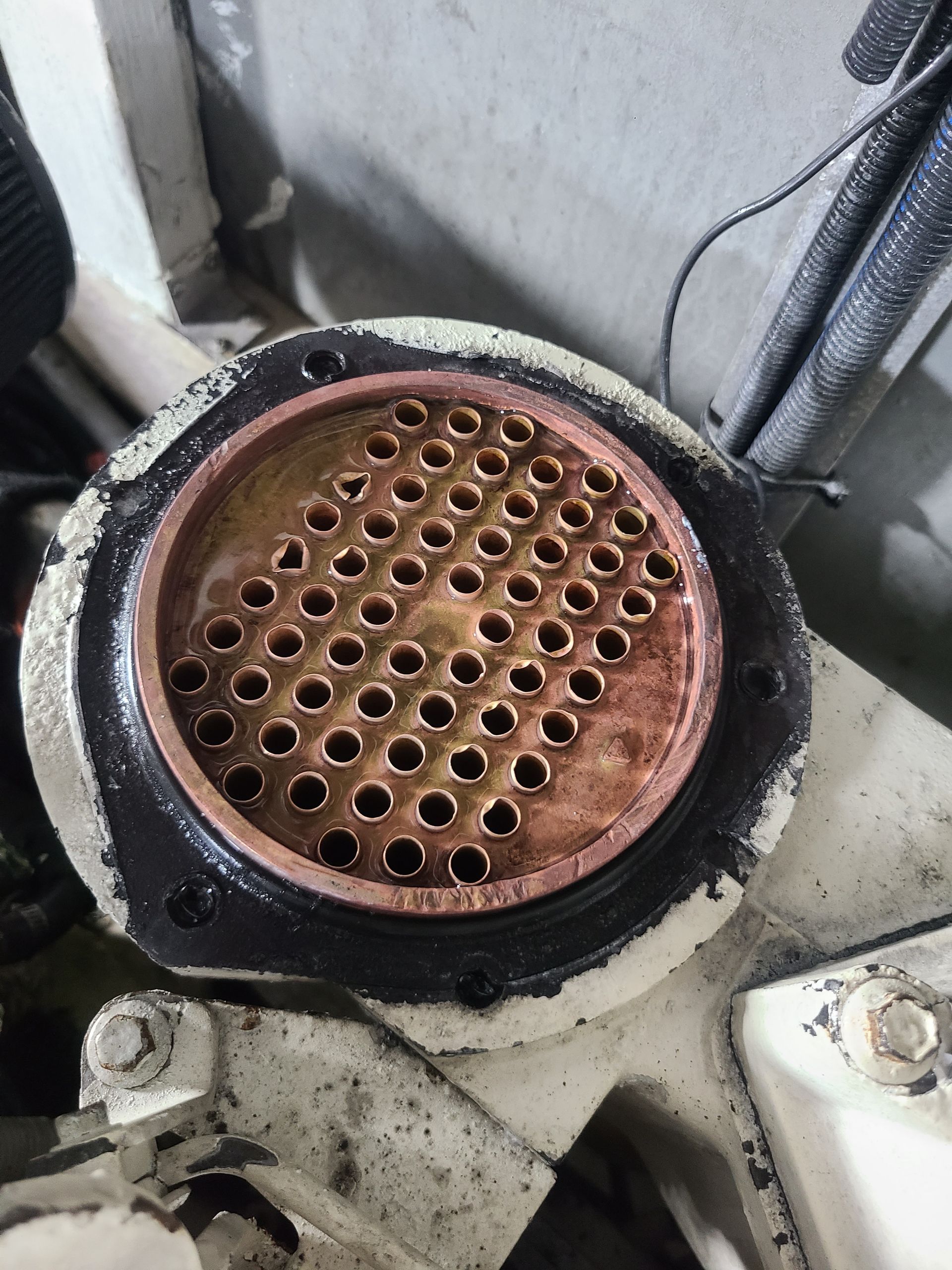 A close up of a copper pipe with holes in it