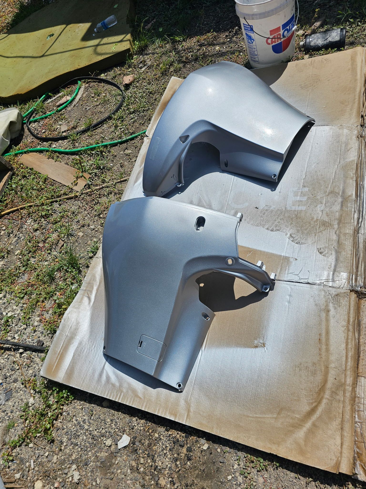 A bucket of pepsi sits next to a cardboard box