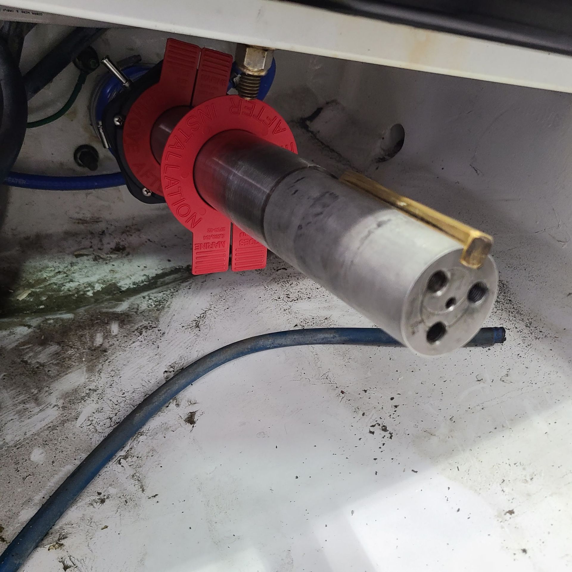 A piece of metal with a red ring around it that says ' stainless steel ' on it