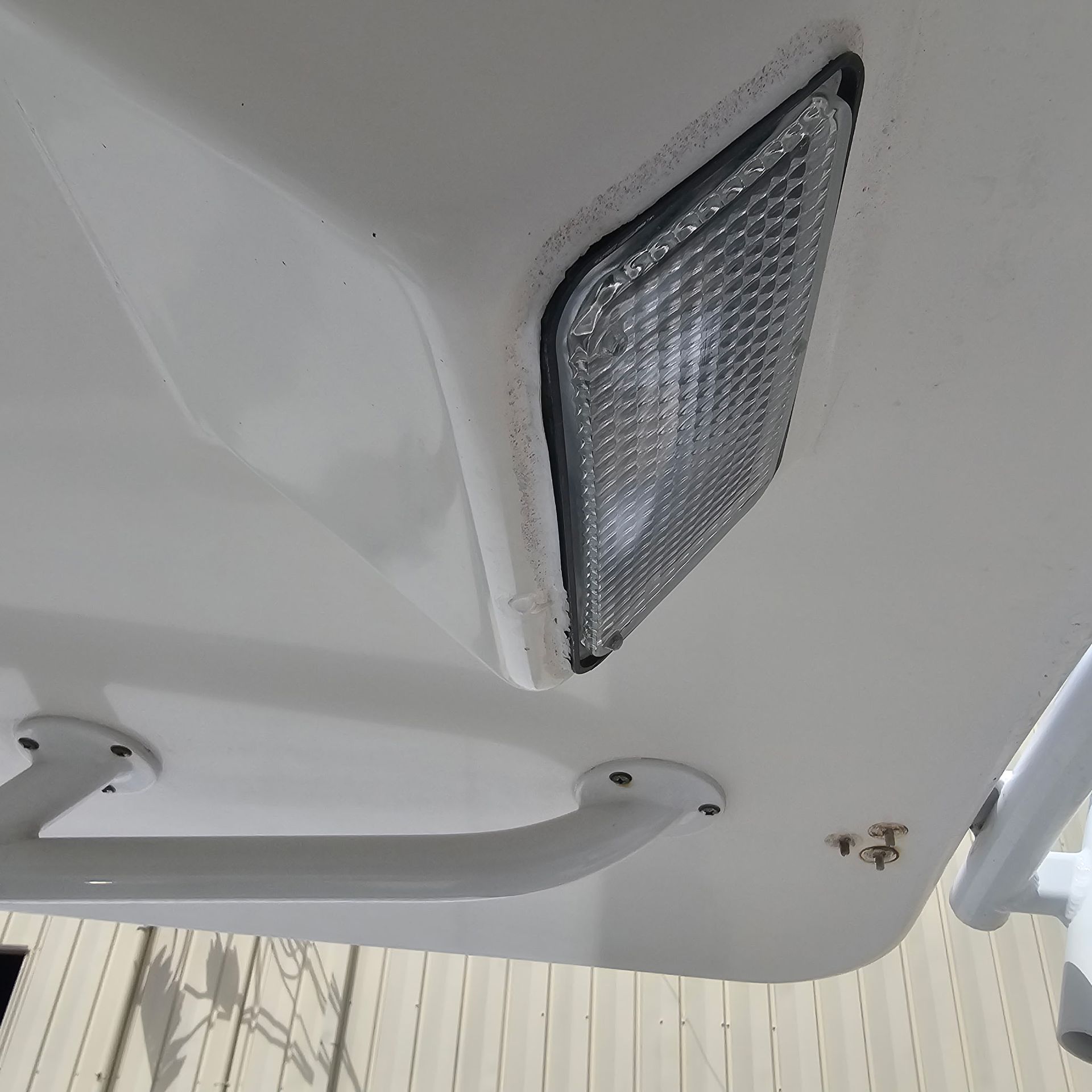 A close up of a light on the side of a boat.