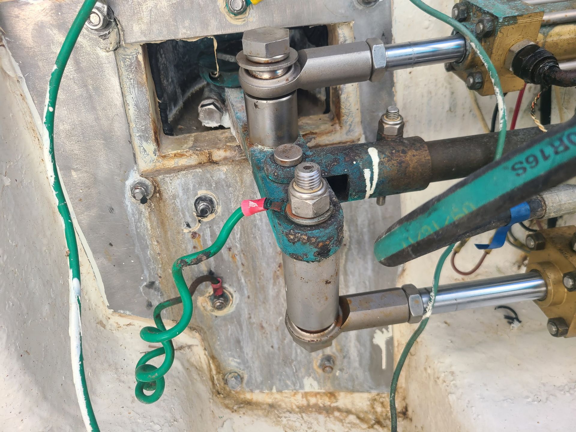 A green wire is connected to a metal object