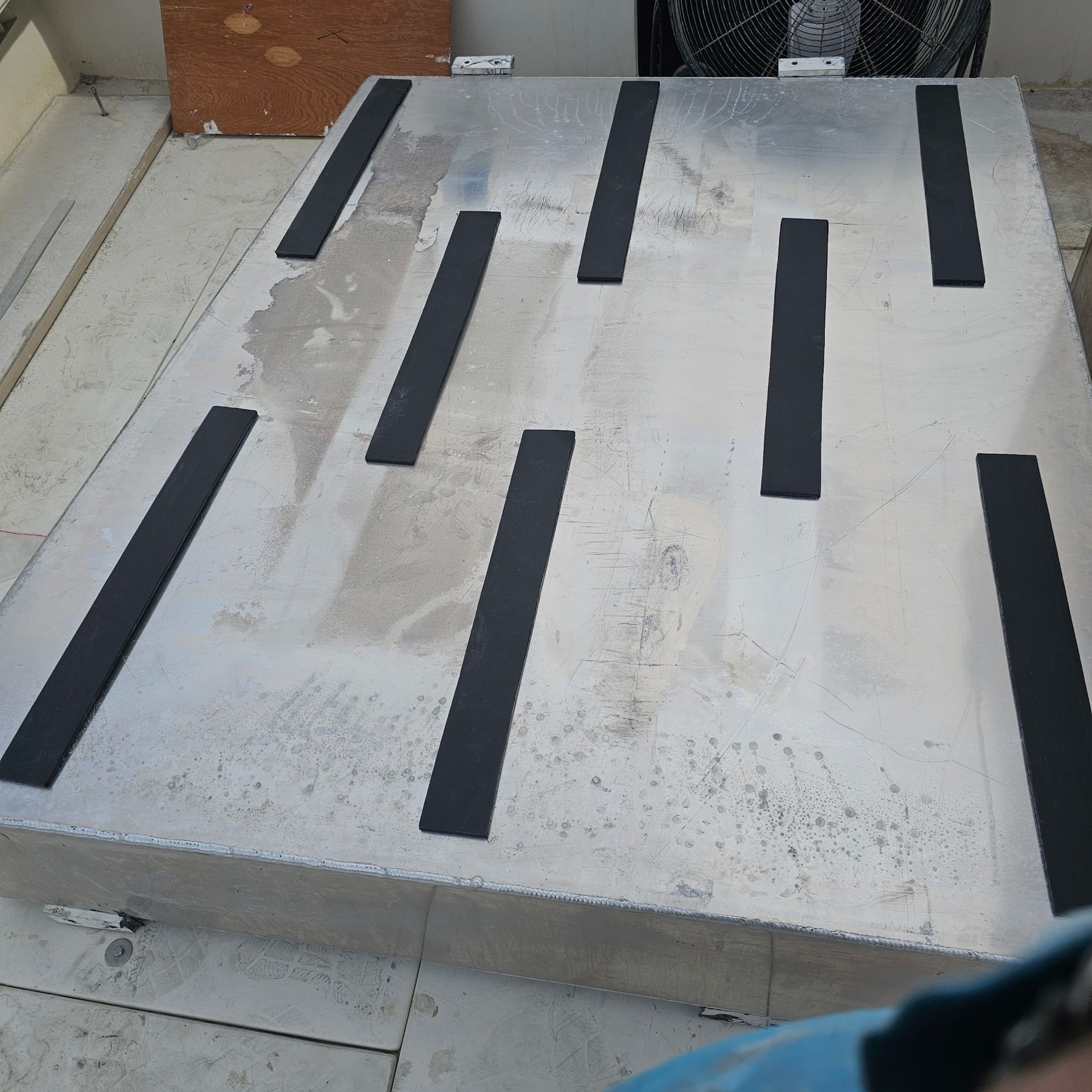 A metal surface with black stripes on it