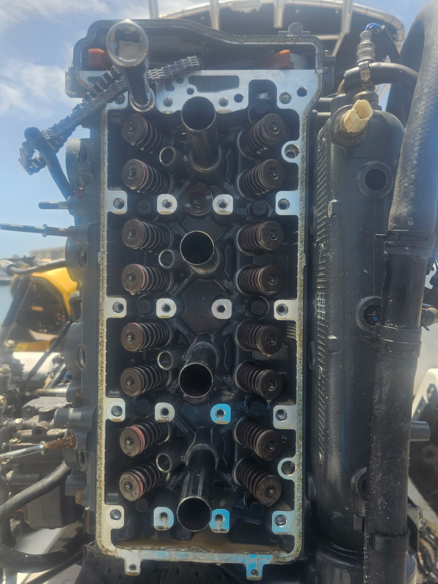 A close up of the cylinder head of a boat engine.