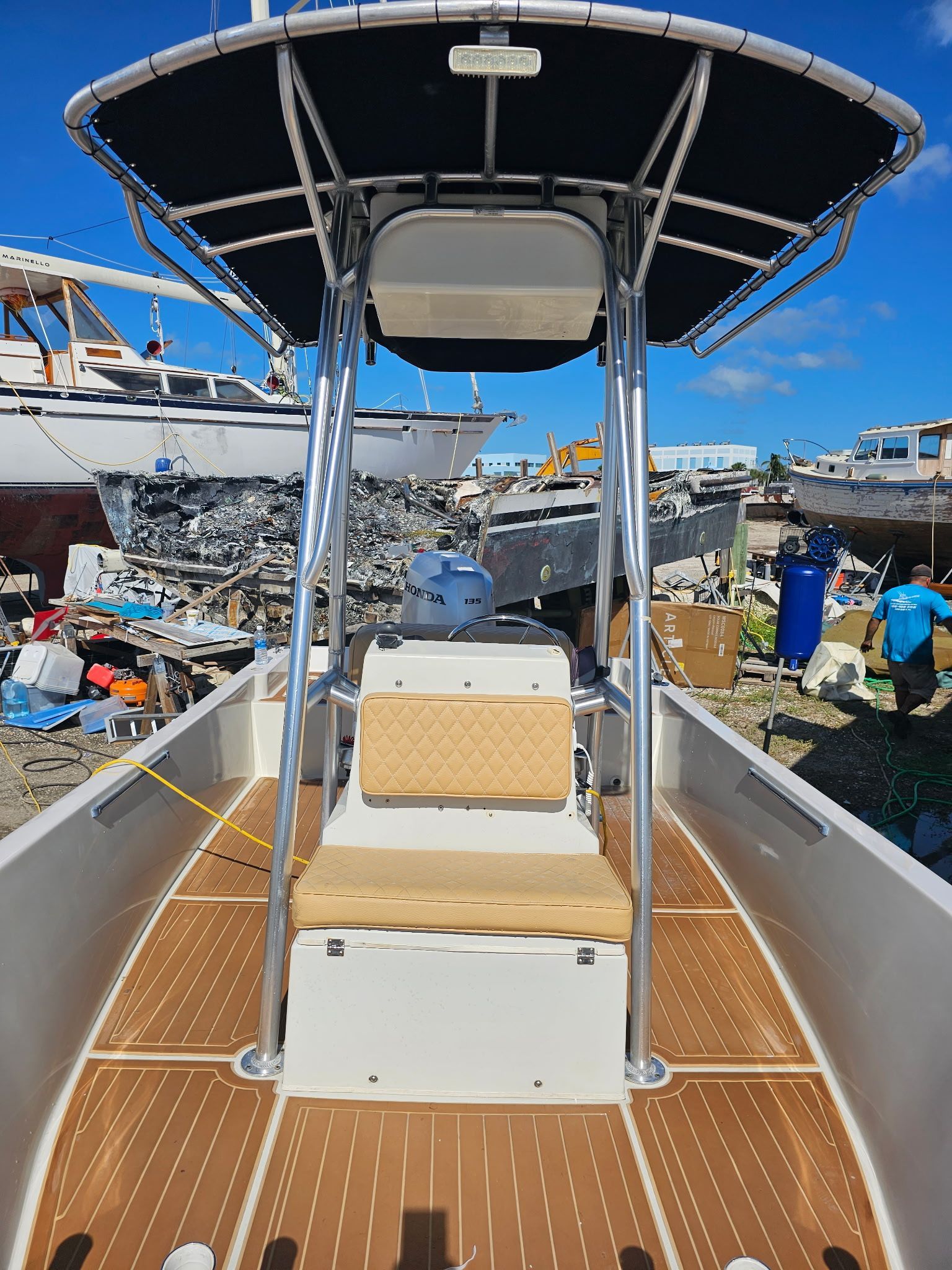 The front of a boat with a canopy and a seat