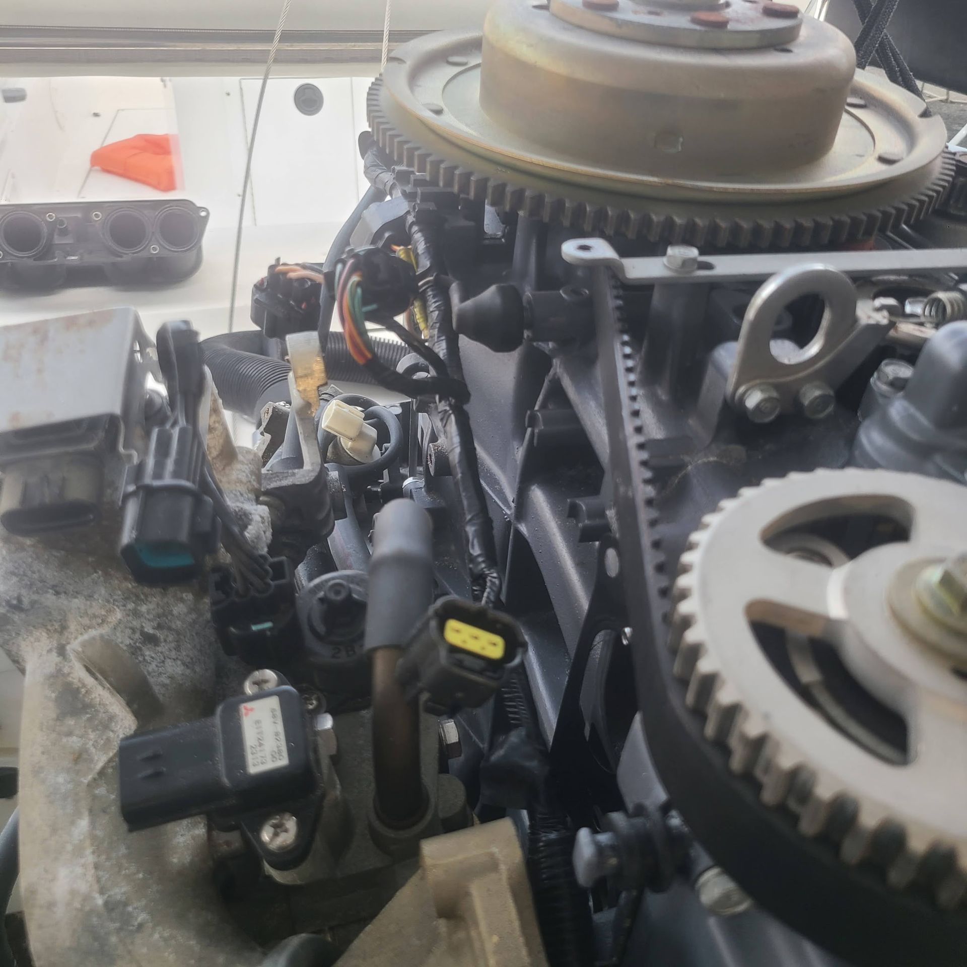 A close up of a boat engine with gears and wires
