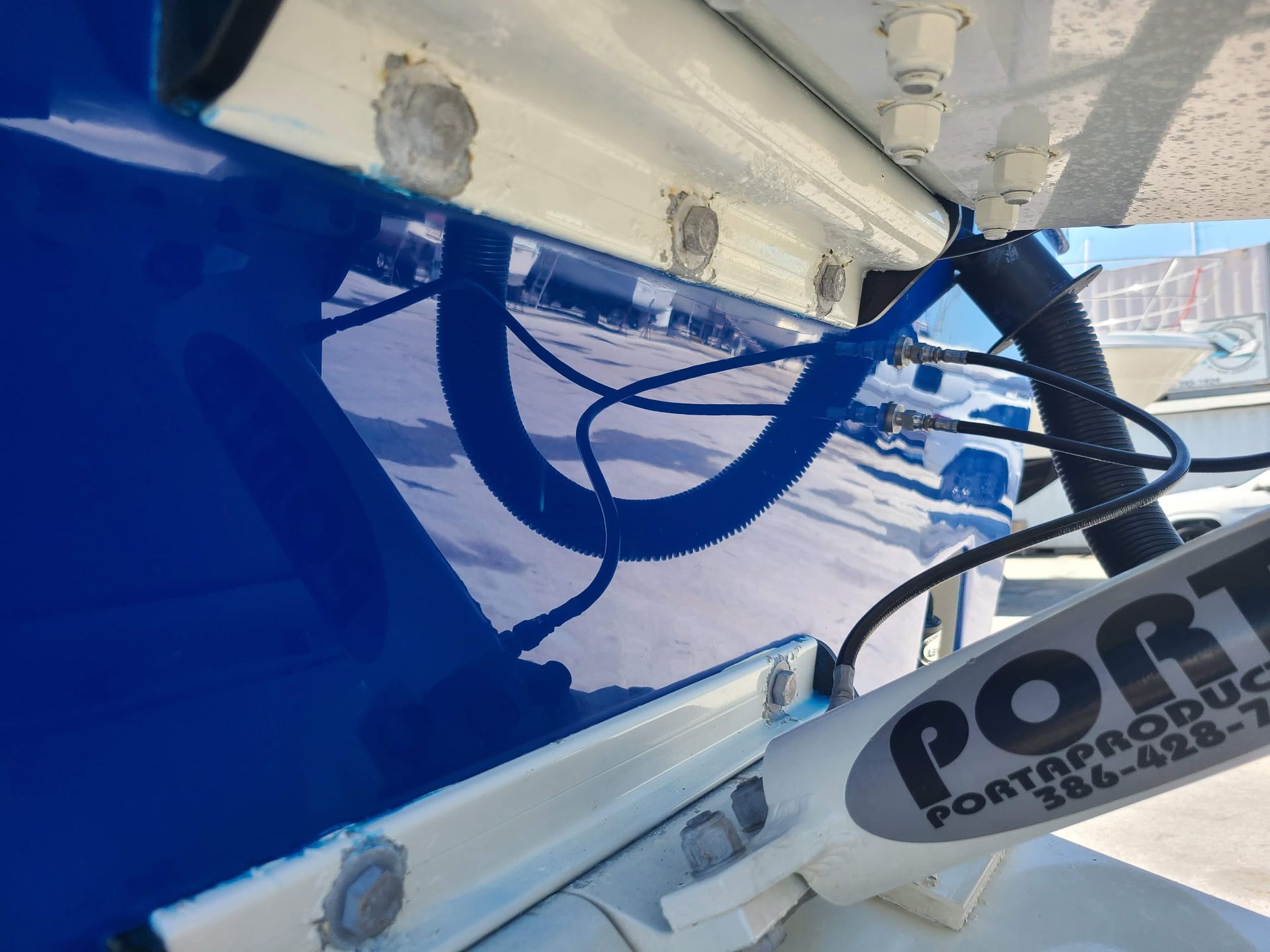 A blue boat with a sign that says port on it