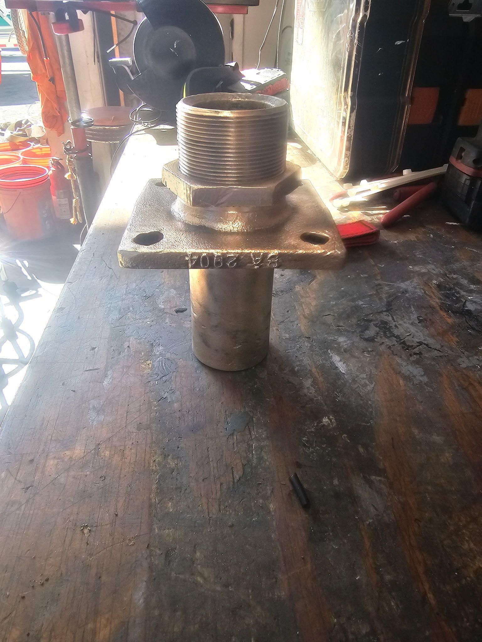 A metal object is sitting on top of a wooden table.