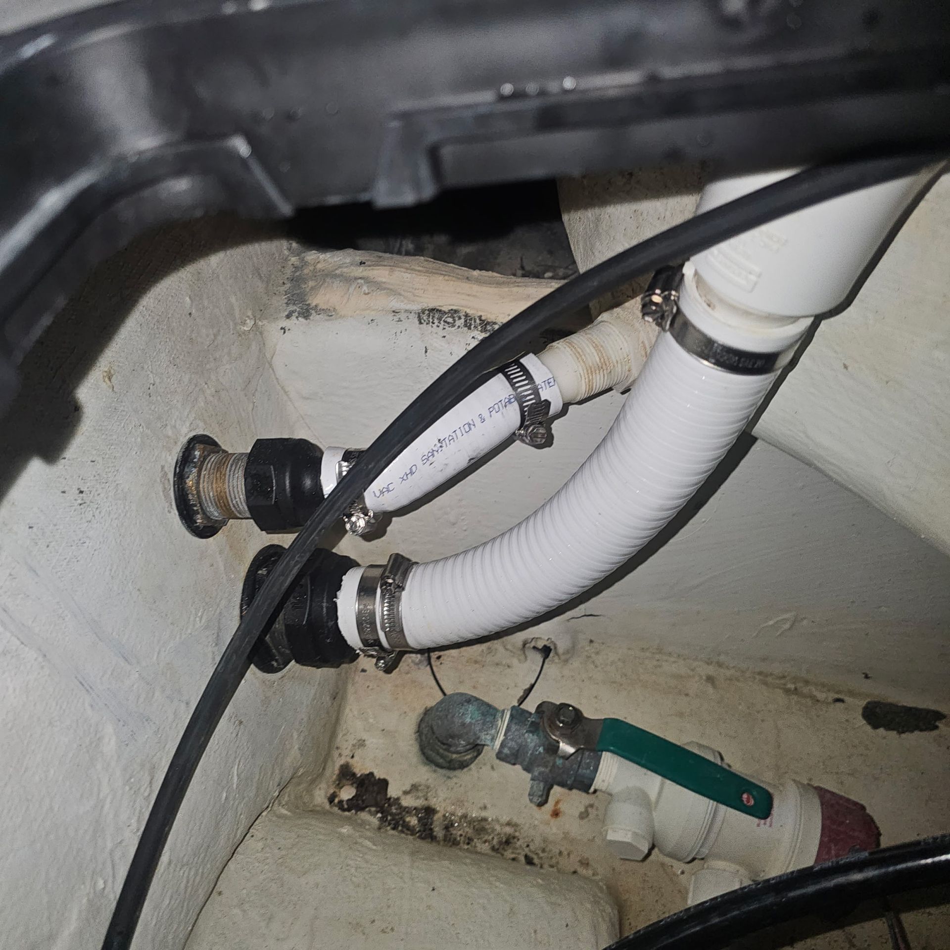 A close up of a pipe with a green valve