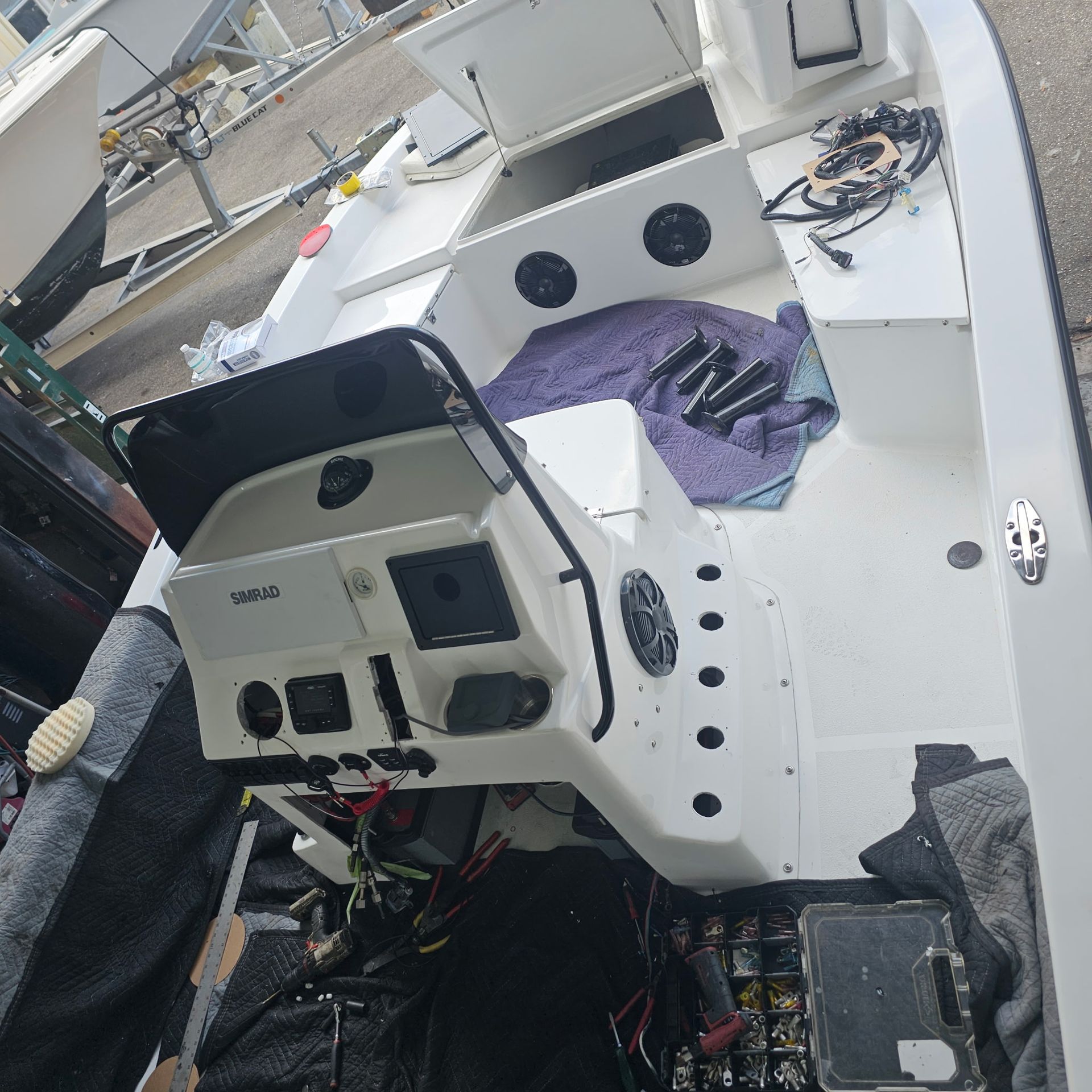 A white boat with a purple towel on the deck