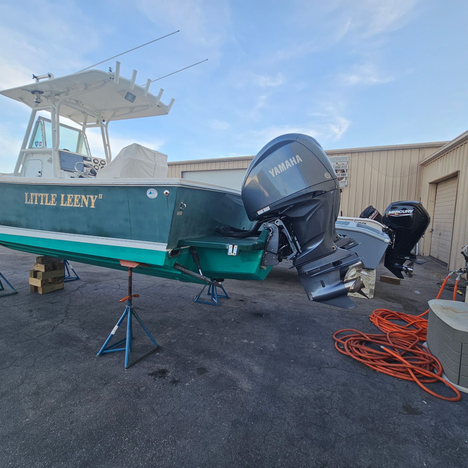 A green boat with the name little lenny on it