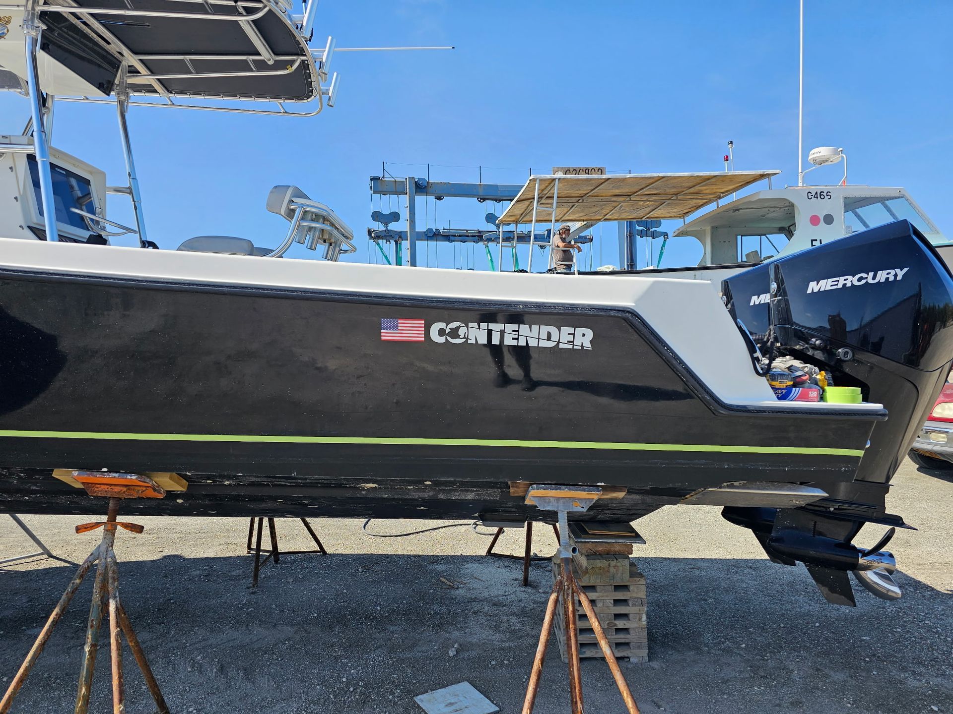 A black and white boat with the name commander on it