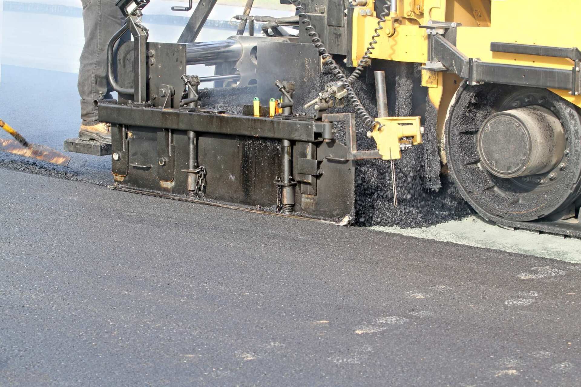 asphalt paving machine laying a new layer of hot mix asphalt