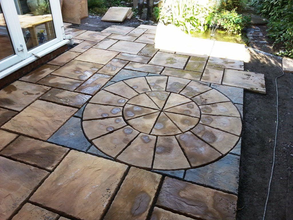A patio with a circular design in the middle of it.