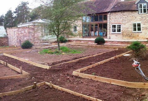 A large house with a garden in front of it.