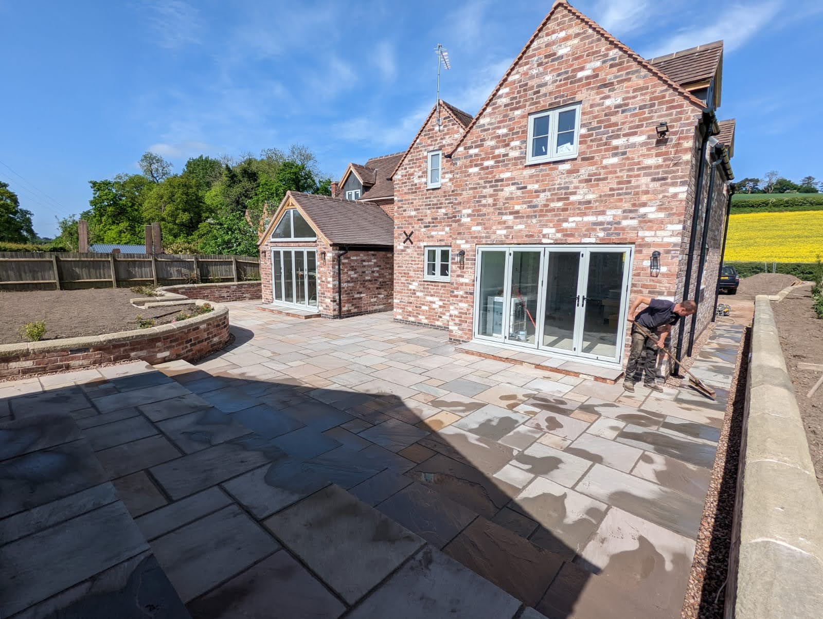 A large brick house with a large patio in front of it