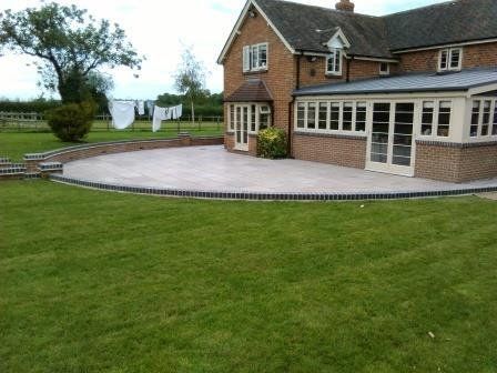A large brick house with a patio in front of it
