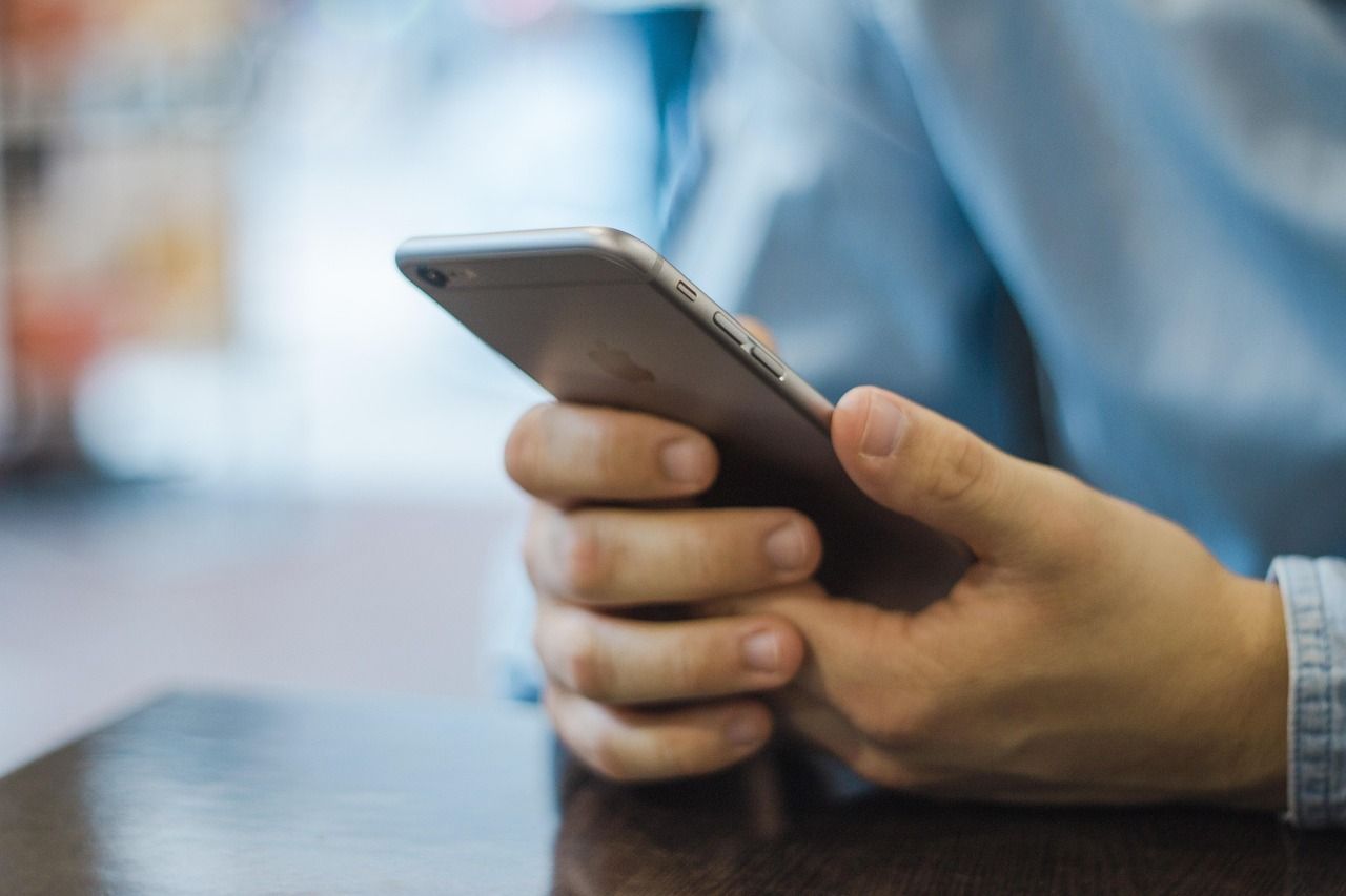 A person is holding a cell phone in their hand