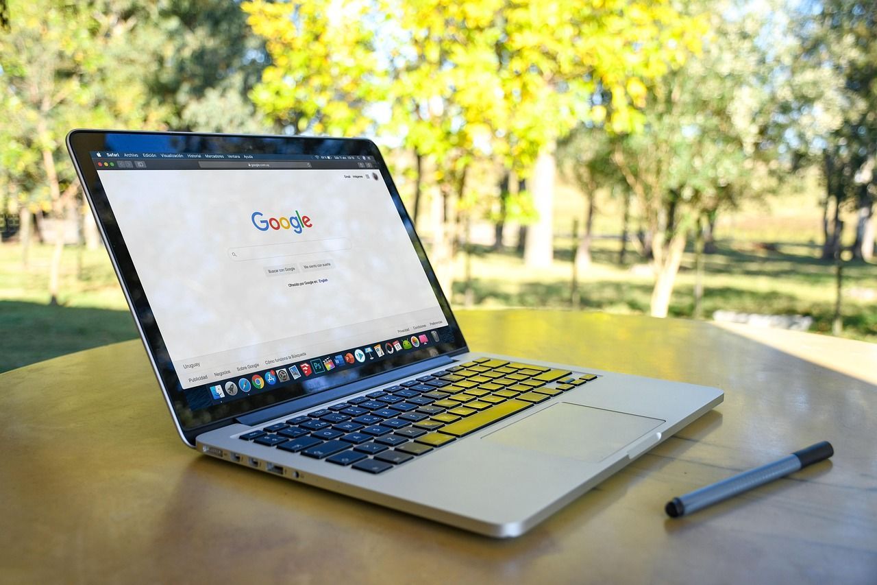 A laptop is open to a Google page