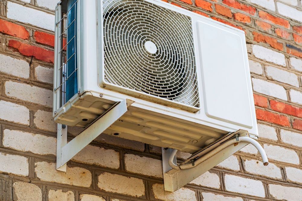 large split system on the wall of the house.