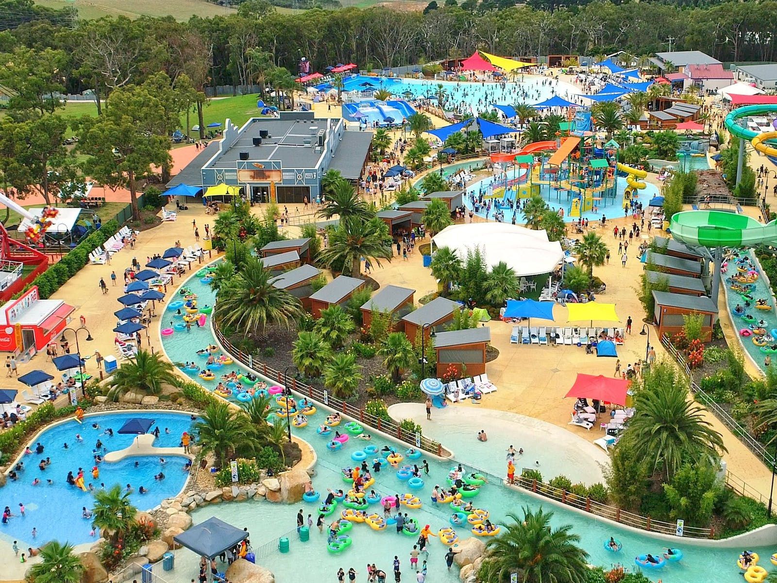 Overhead image of Gumbuya world, featuring  prominent water park activities and plentiful palm trees