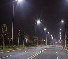 Street lights on at night over road