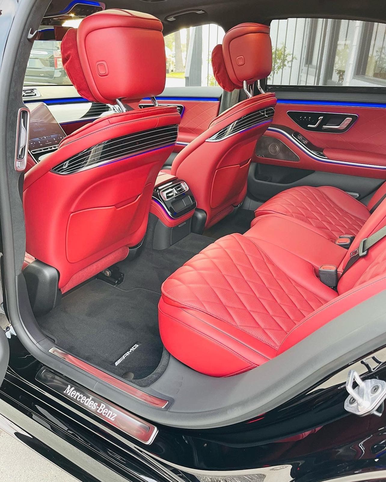 the interior of a black mercedes benz s class with red seats .