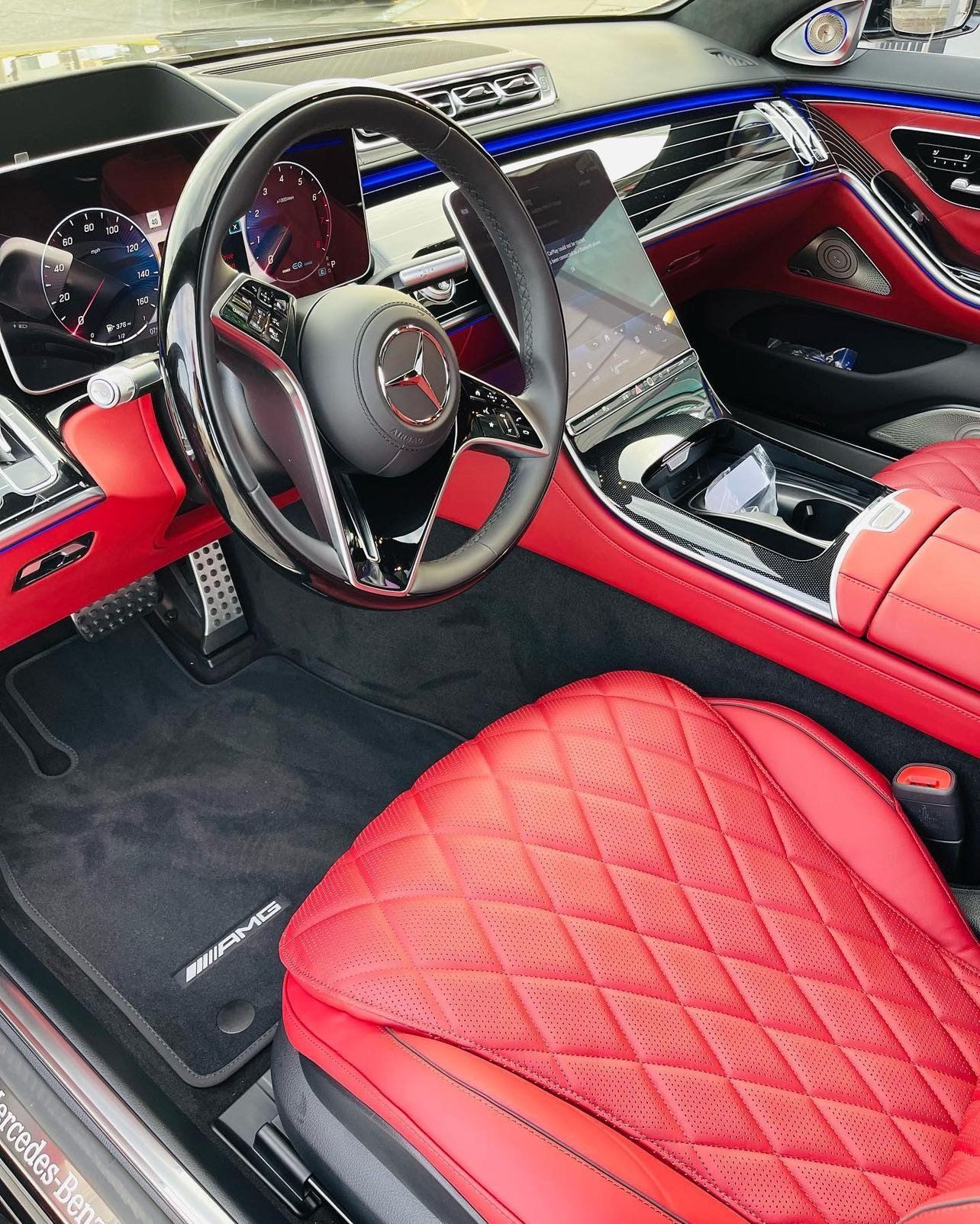 the interior of a car with red seats and a steering wheel