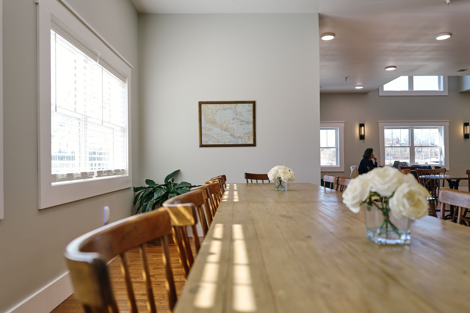 A Long Table Set With White Roses at Three Story Coffee's Private Event Space in Mid-Missouri.