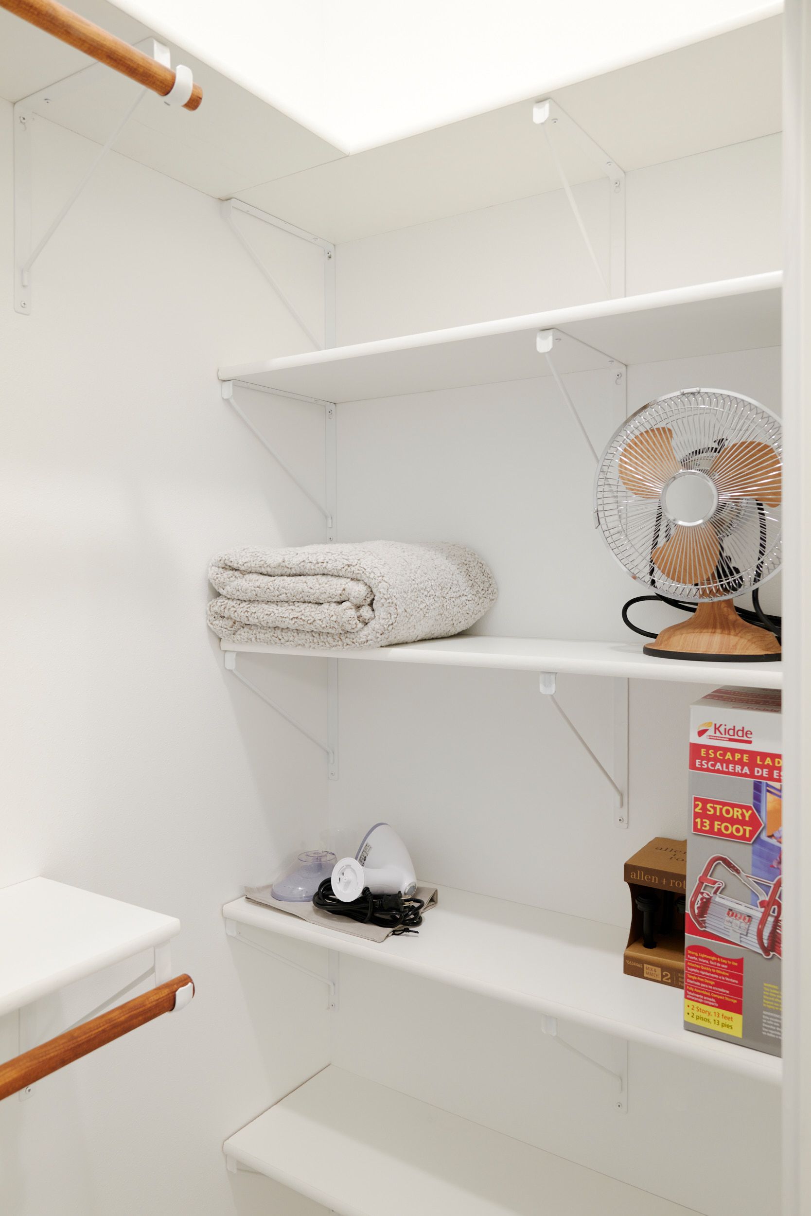 Organized Shelves With a Towel & Fan at Three Story Coffee's Vacation Rental in Central Missouri.