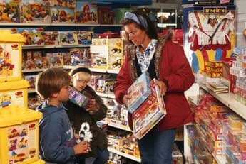 Lady showing kids some board games - Fun toys in Seattle, WA