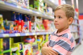 Games for Sale — Boy wondering in toy store in Seattle, WA