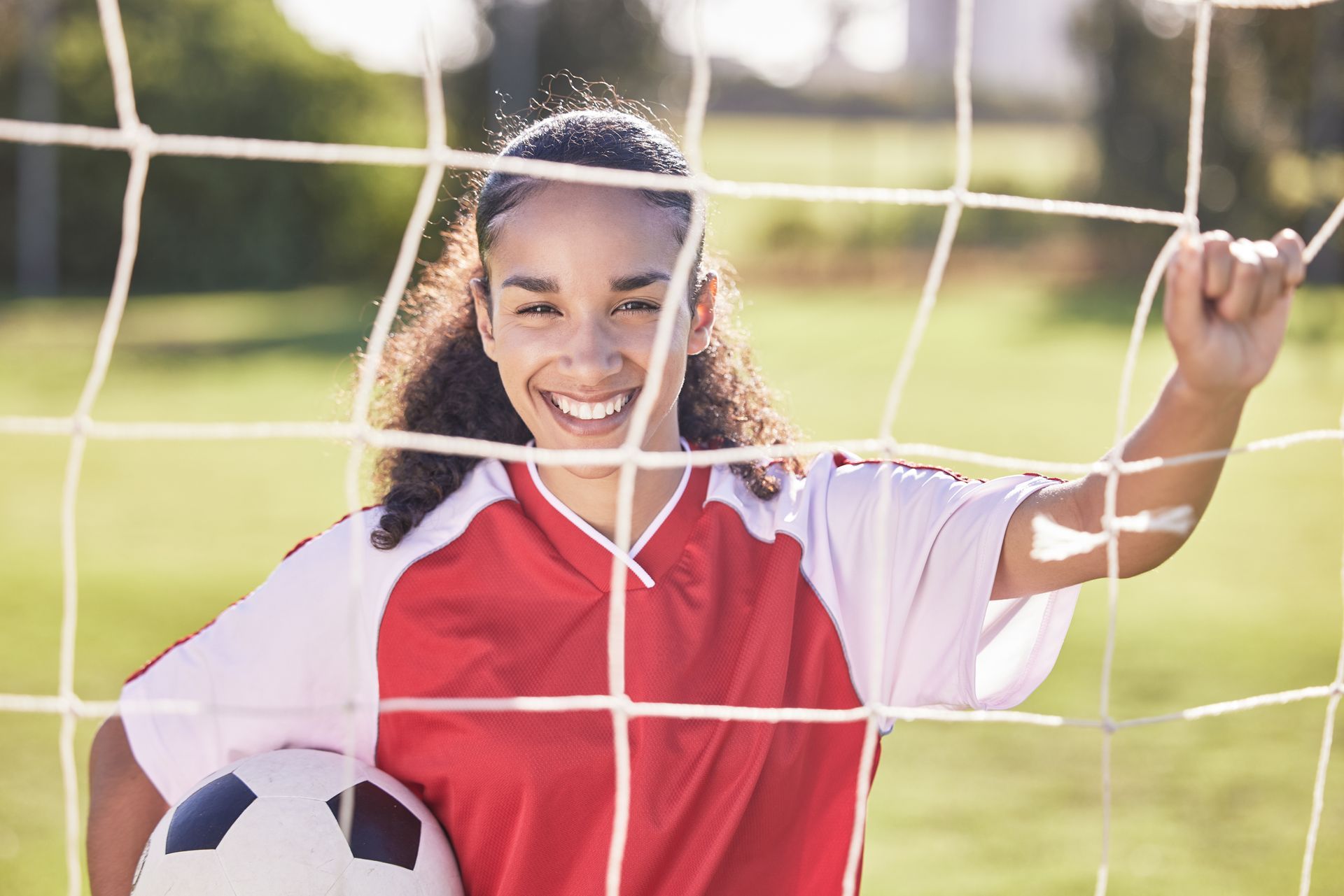 college aged young woman playing soccer