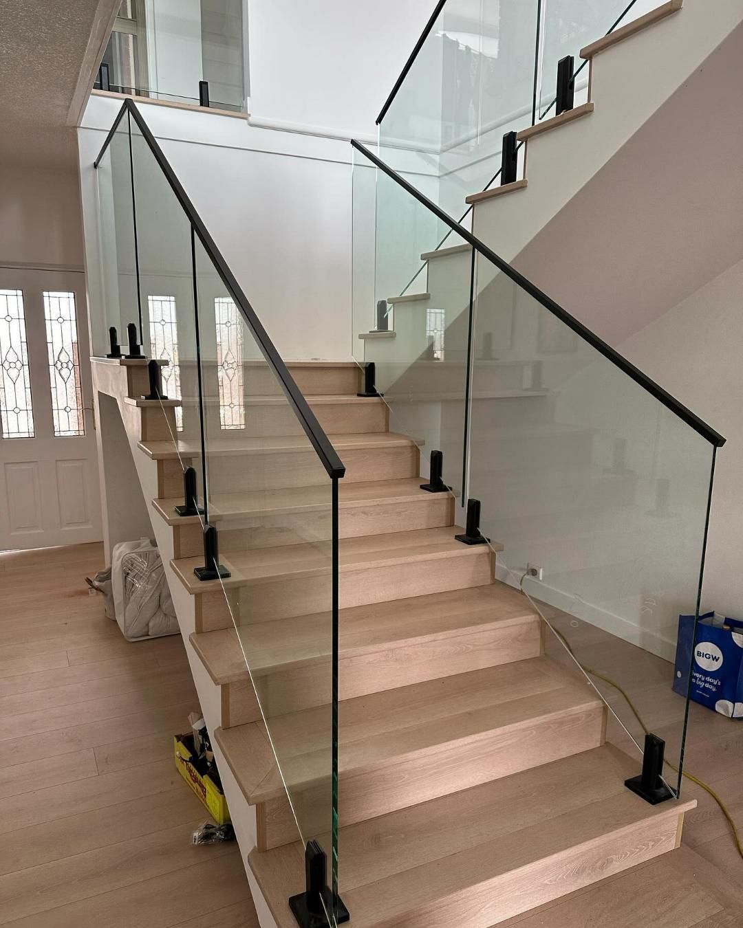 A Staircase with A Glass Railing and Wooden Steps — Optimum Aluminium Fabrication in Barrack Heights, NSW