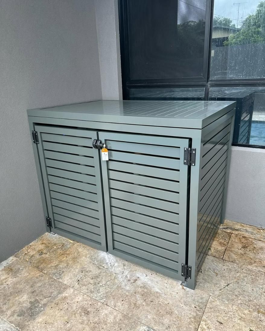 A Metal Box with Two Doors Is Sitting on A Patio Next to A Window — Optimum Aluminium Fabrication in Barrack Heights, NSW