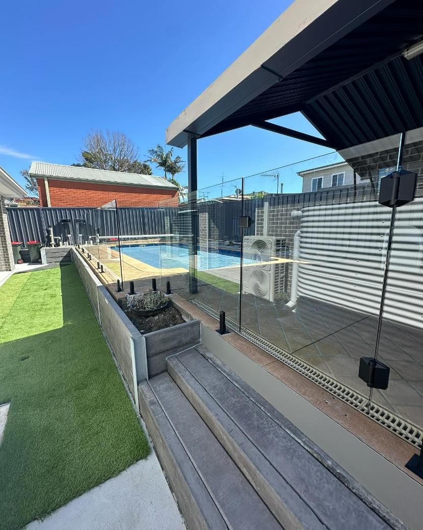 There Is a Swimming Pool in The Backyard of A House — Optimum Aluminium Fabrication in Barrack Heights, NSW