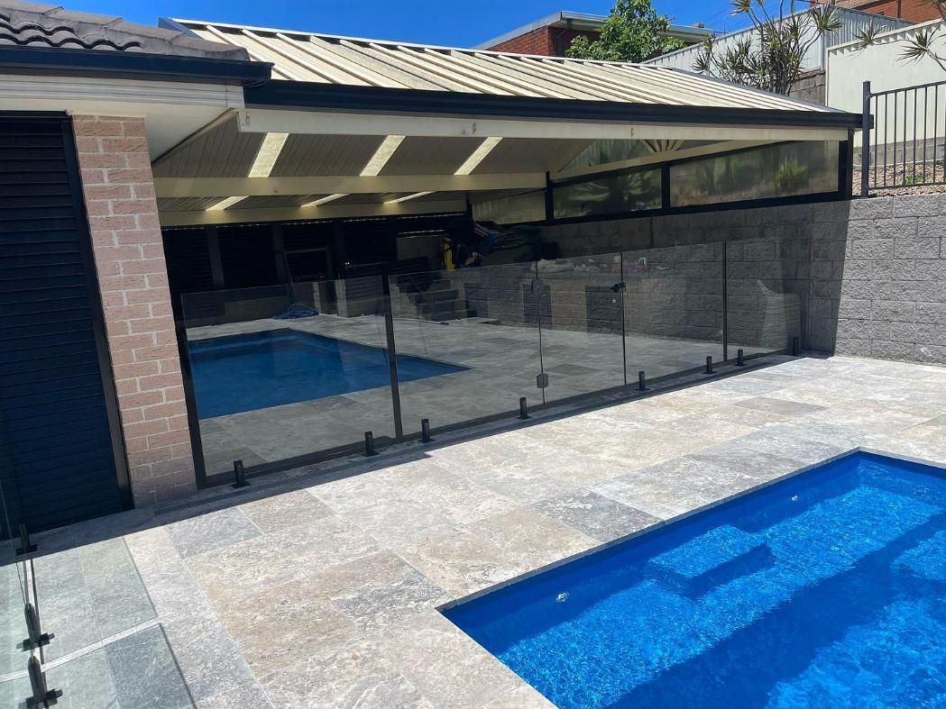 There Is a Swimming Pool in The Backyard of A House — Optimum Aluminium Fabrication in Barrack Heights, NSW