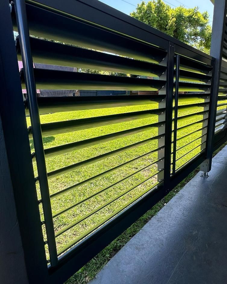 A Fence with A View of A Grassy Field Behind It — Optimum Aluminium Fabrication in Barrack Heights, NSW