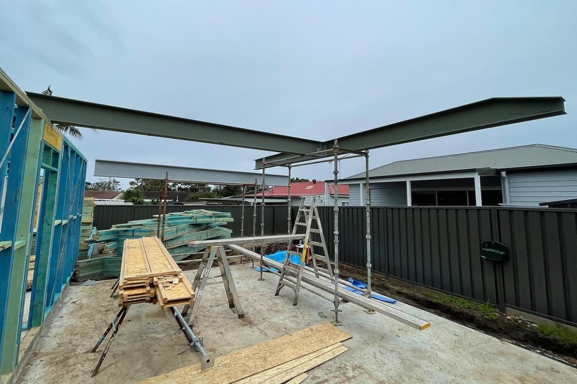 A Wooden Table and A Ladder Are Sitting in Front of A Building — Optimum Aluminium Fabrication in Barrack Heights, NSW
